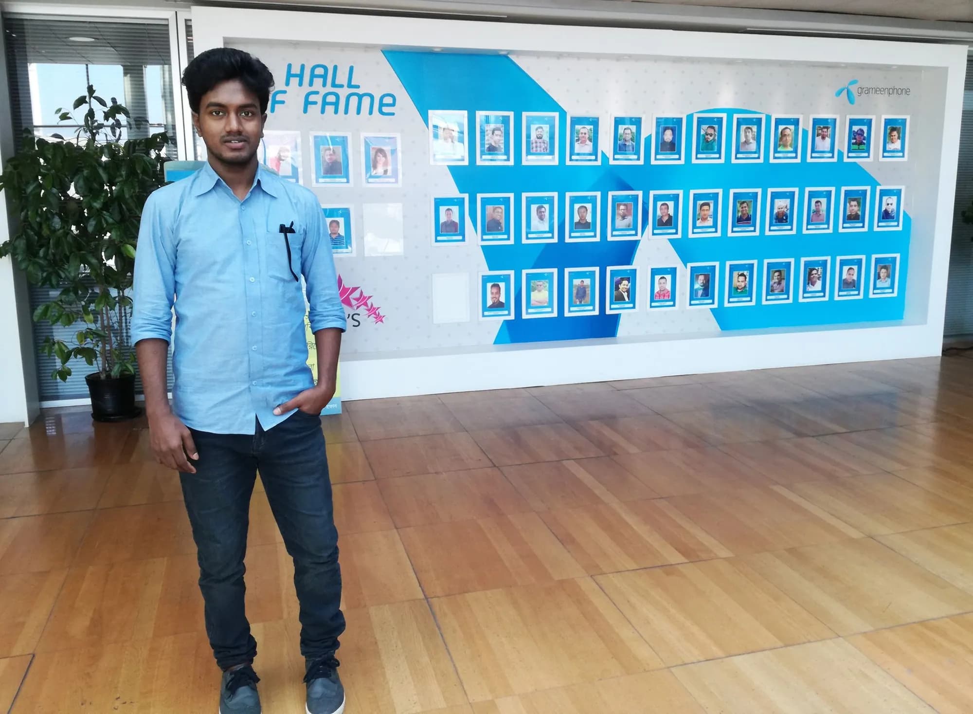Standing in front of the Grameenphone Hall of Fame wall