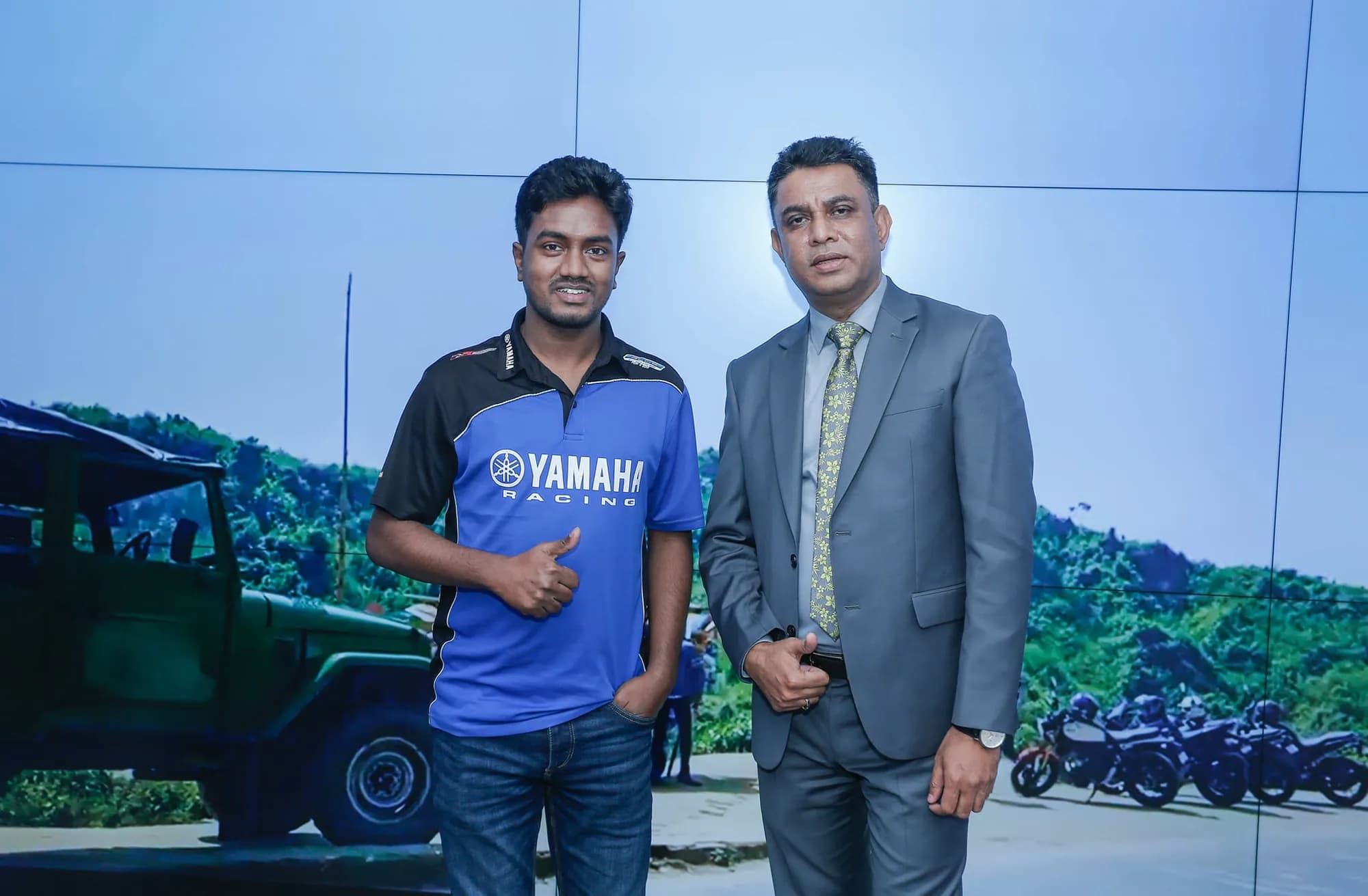 Razu Rahman in a Yamaha racing shirt beside a colleague